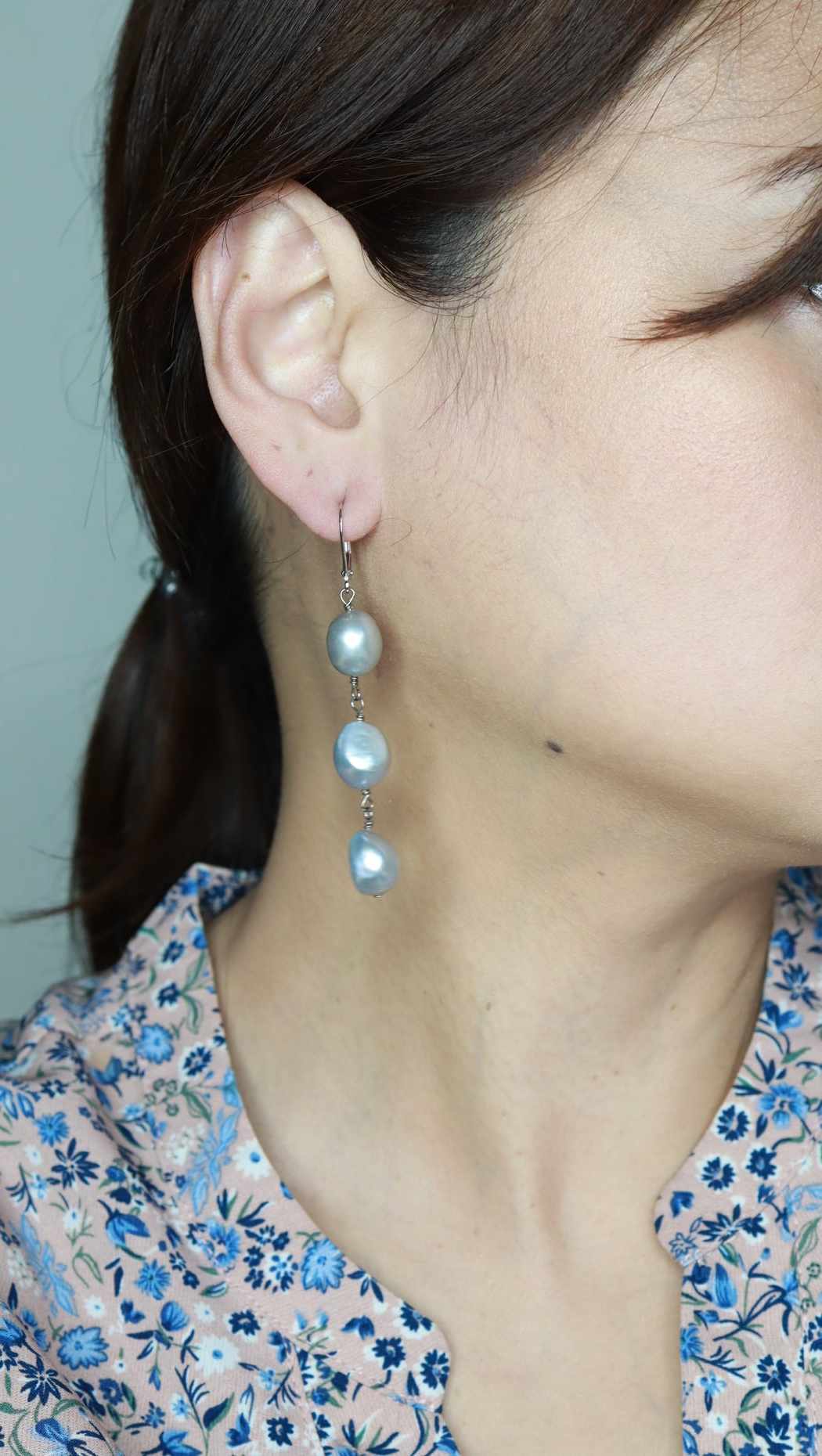 Long dangling pearl earrings